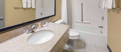 A bathroom with a sink, toilet, and bathtub.