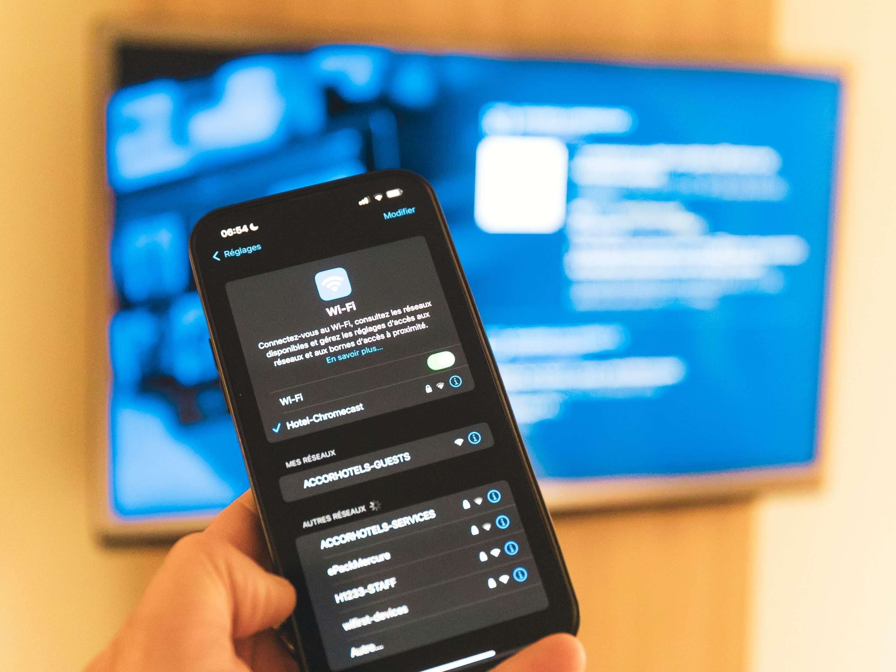A smartphone displaying a Wi-Fi settings screen with options for 'Hotel-Chromecast' and 'AccorHotels-GUESTS.'