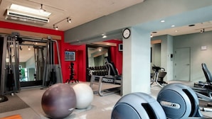 A gym with exercise equipment, including a treadmill, stationary bikes, and exercise balls. - Coast Seattle Downtown Hotel by APA (Seattle)