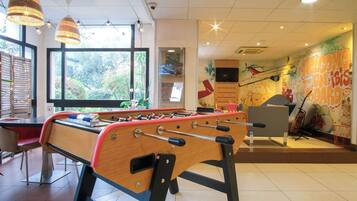 Relax in this stylish room with a foosball table, flat-screen TV, and comfortable sofa.