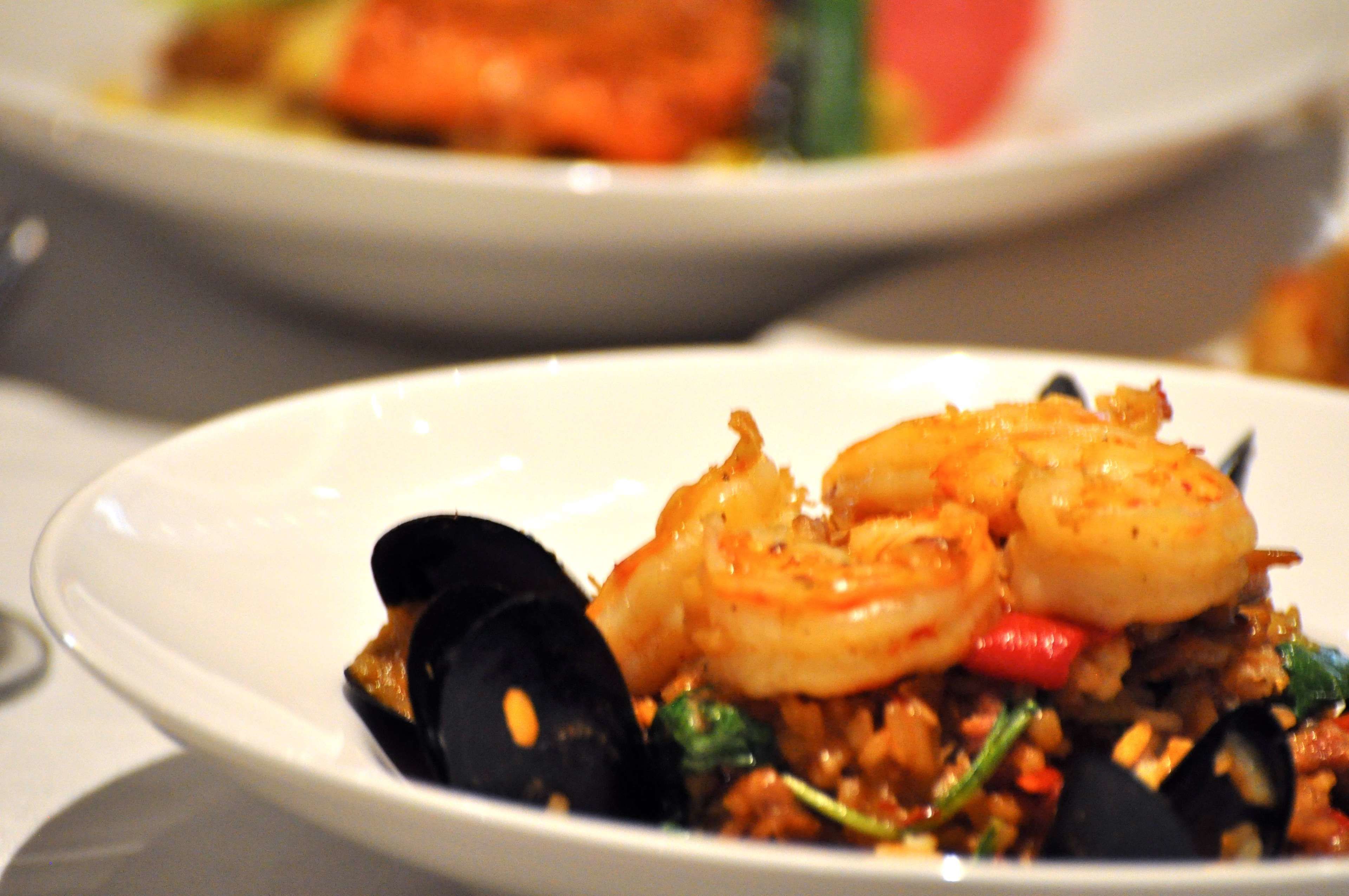 Une assiette de fruits de mer, avec des crevettes et des moules.