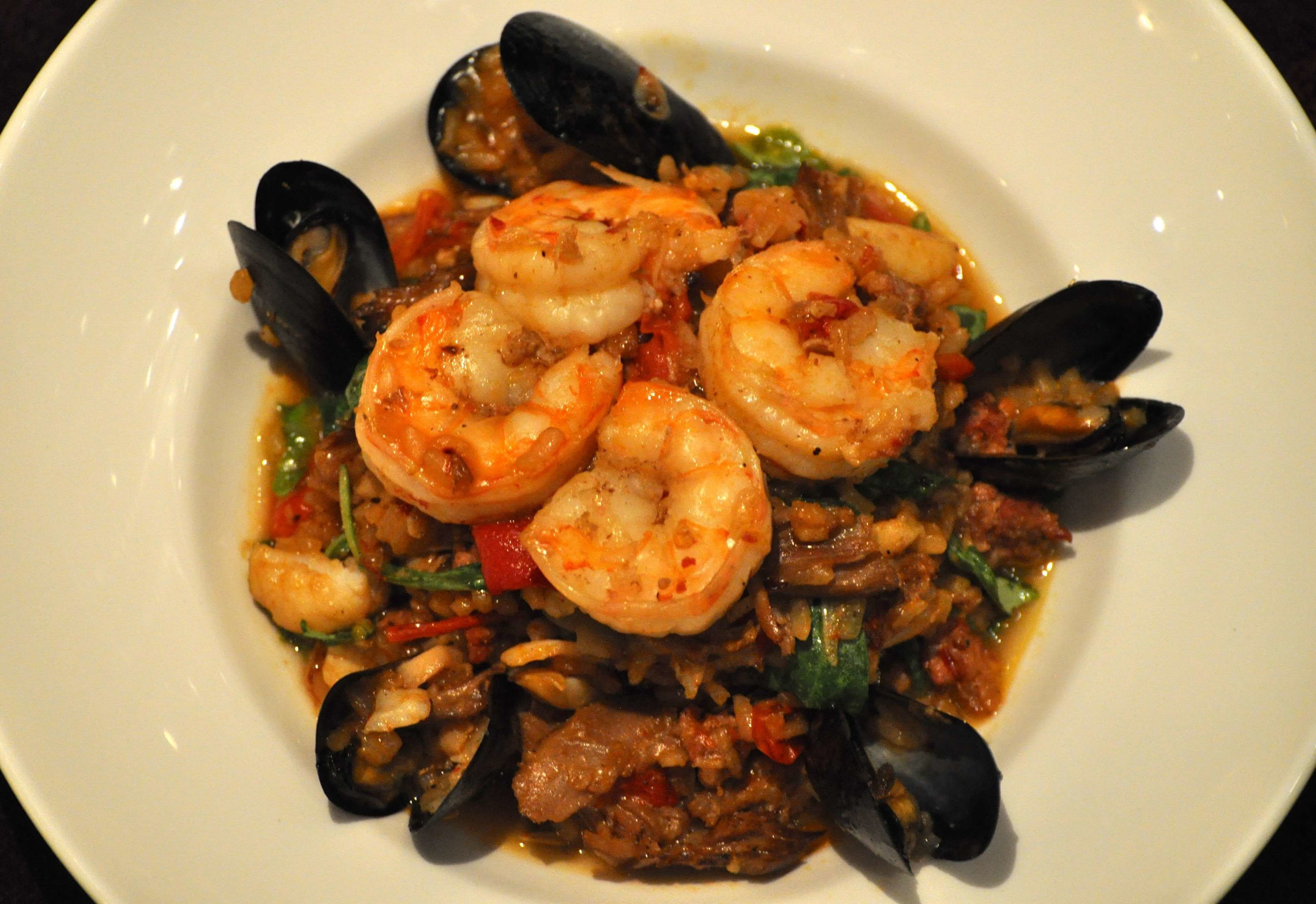 Un plato de mariscos con camarones y mejillones.