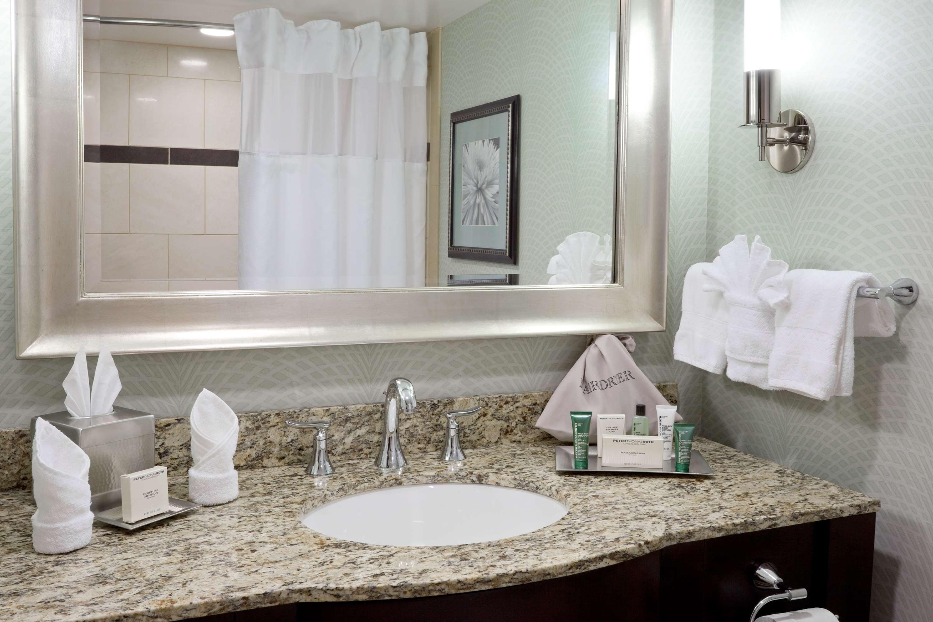 designer toiletries, hair dryer, towels