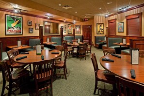 A restaurant with booths and tables, wooden decor, and menu stands.