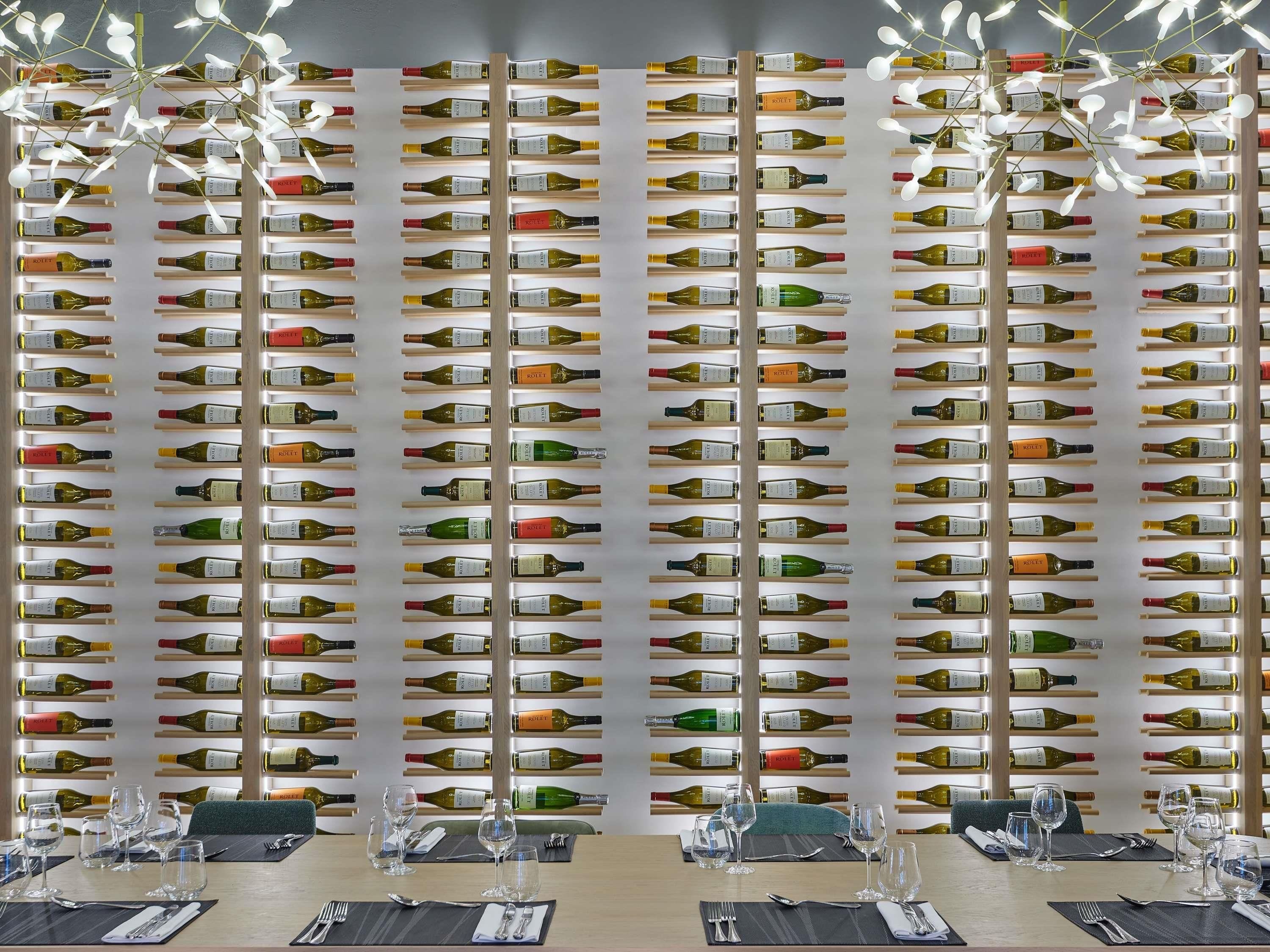 A wall of wine bottles in a restaurant setting.