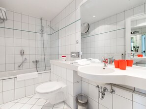 Bathtub, eco-friendly toiletries, hair dryer, towels
