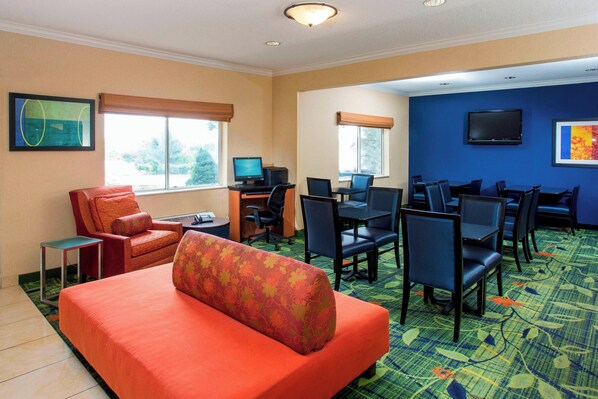 A hotel room with a large bed, a desk with a computer, multiple chairs, and a television on the wall. - Fairfield Inn Middletown Monroe (Middletown)