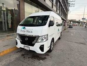 A white van with 'POZA RICA HOTEL CENTRO' branding parked on a street.