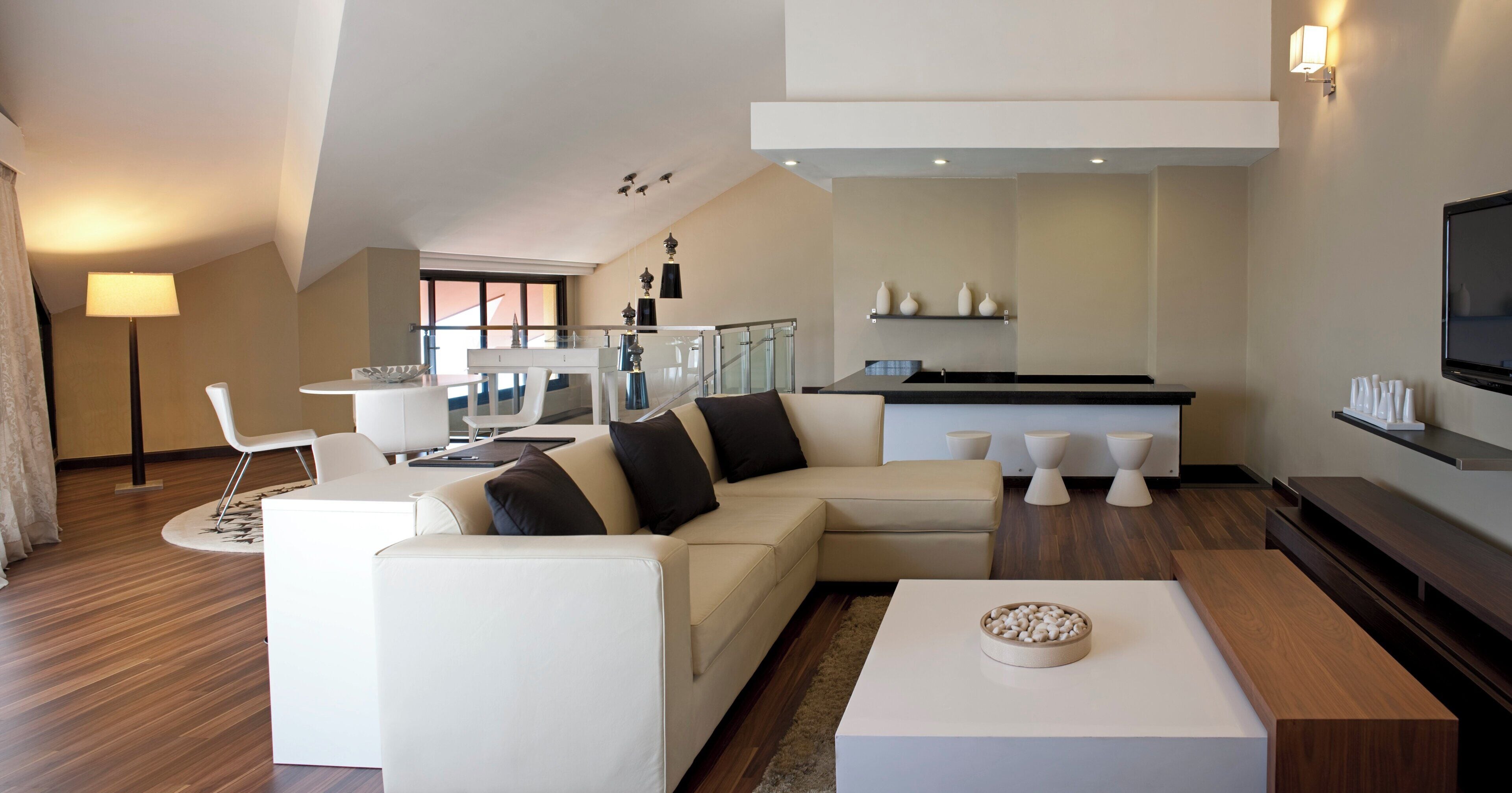 A modern living room with a sectional sofa, a coffee table, and a TV.