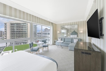 Junior Suite with Hollywood Hills View | Living area | 55-inch LCD TV with cable channels, Smart TV, iPod dock at The Beverly Hilton