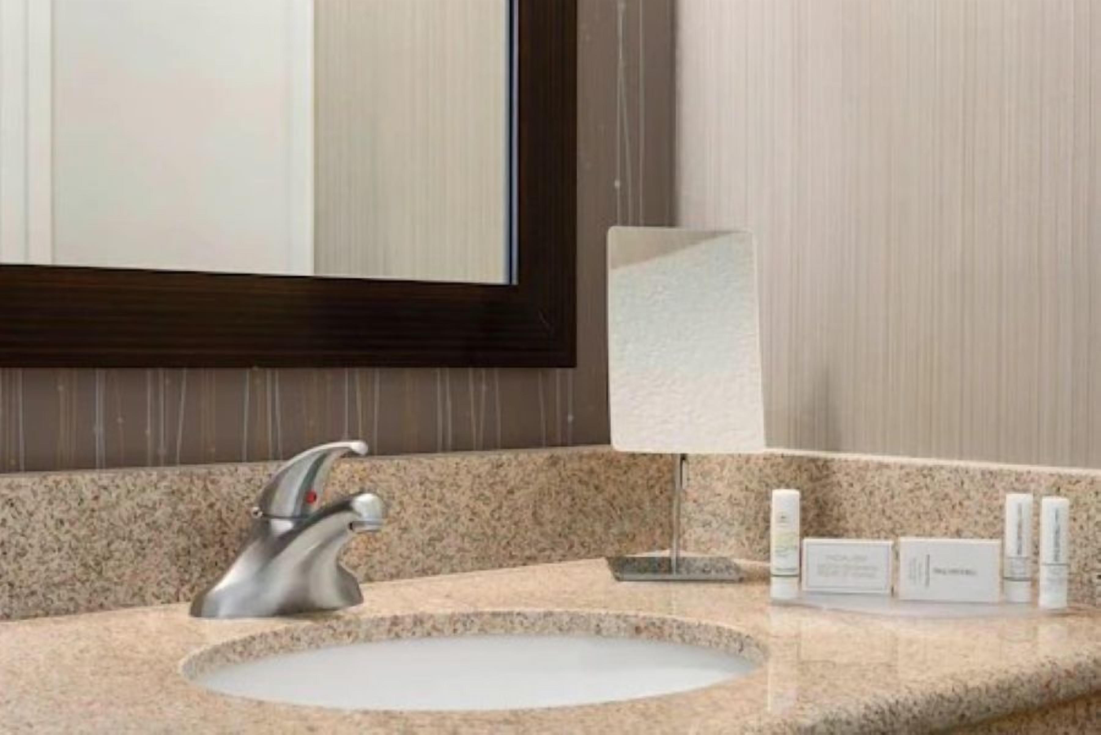 combined shower/bathtub, designer toiletries, hair dryer, towels