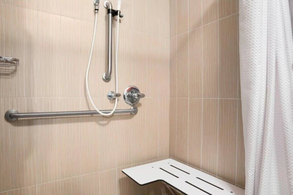 room, 1 king bed (mobility/hearing access, roll-in shwr) | bathroom | combined shower/bathtub, designer toiletries, hair dryer, towels