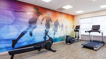 A gym with exercise equipment including treadmills, an elliptical, and a stationary bike.