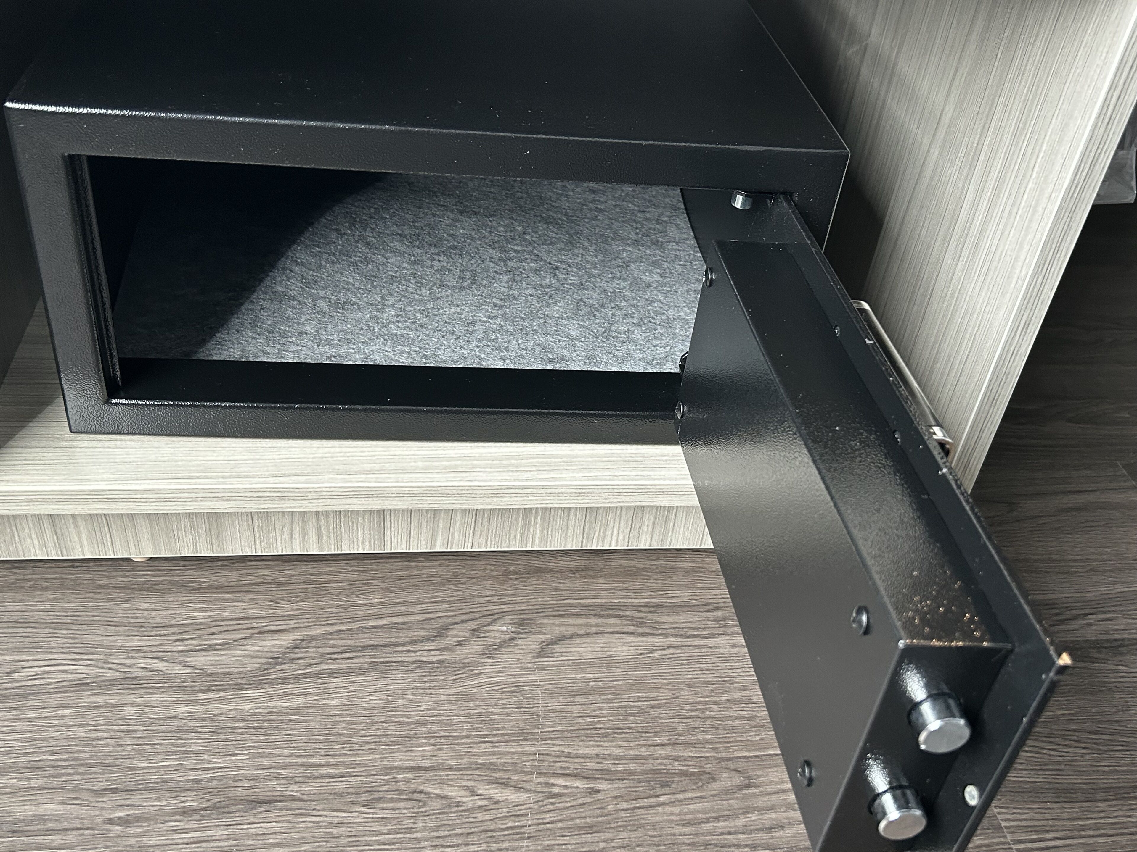 A black metal structure with a shelf, possibly a part of a piece of furniture or equipment.