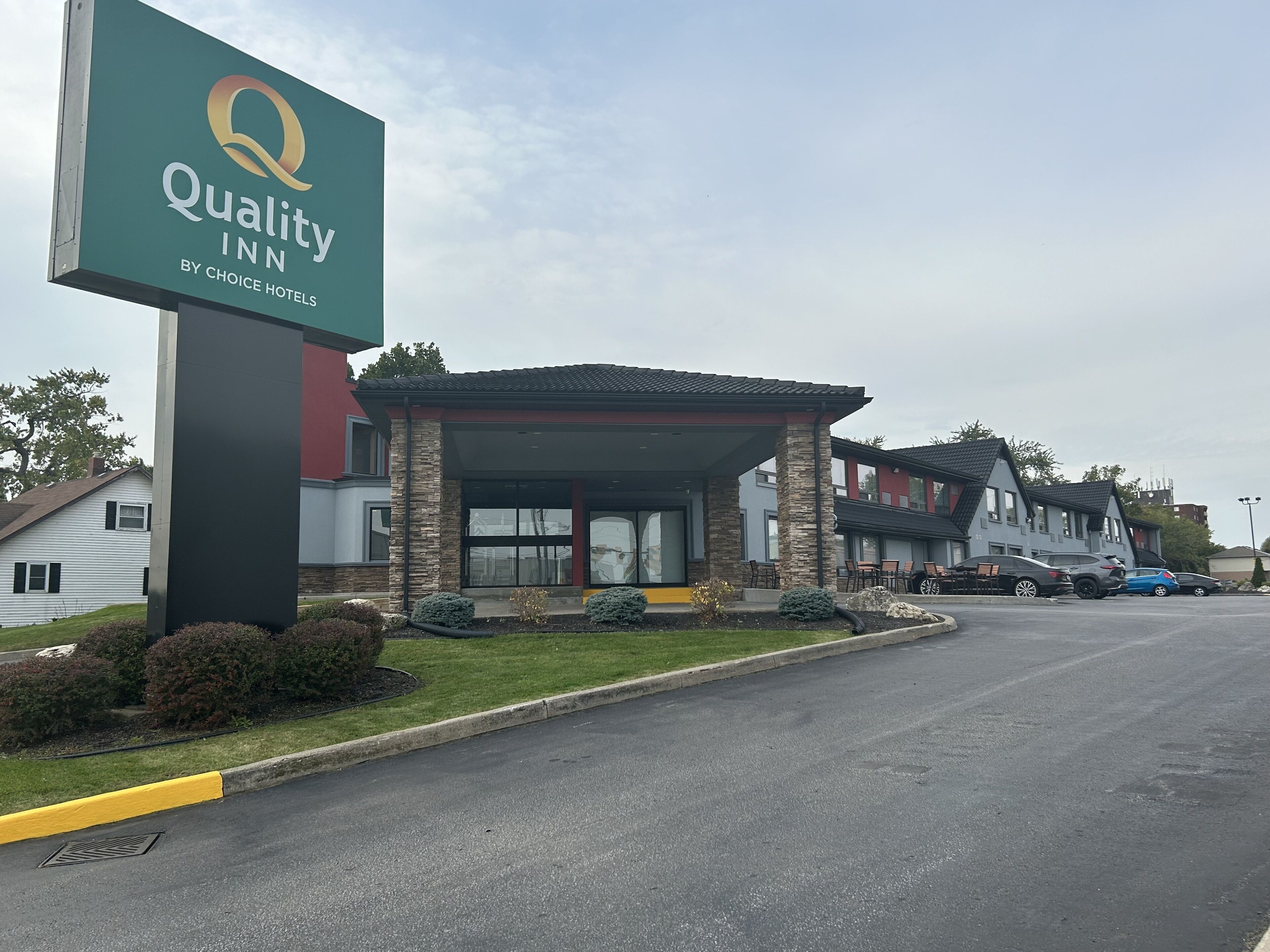 A Quality Inn by Choice Hotels with a modern design, featuring a covered entrance and multiple units.