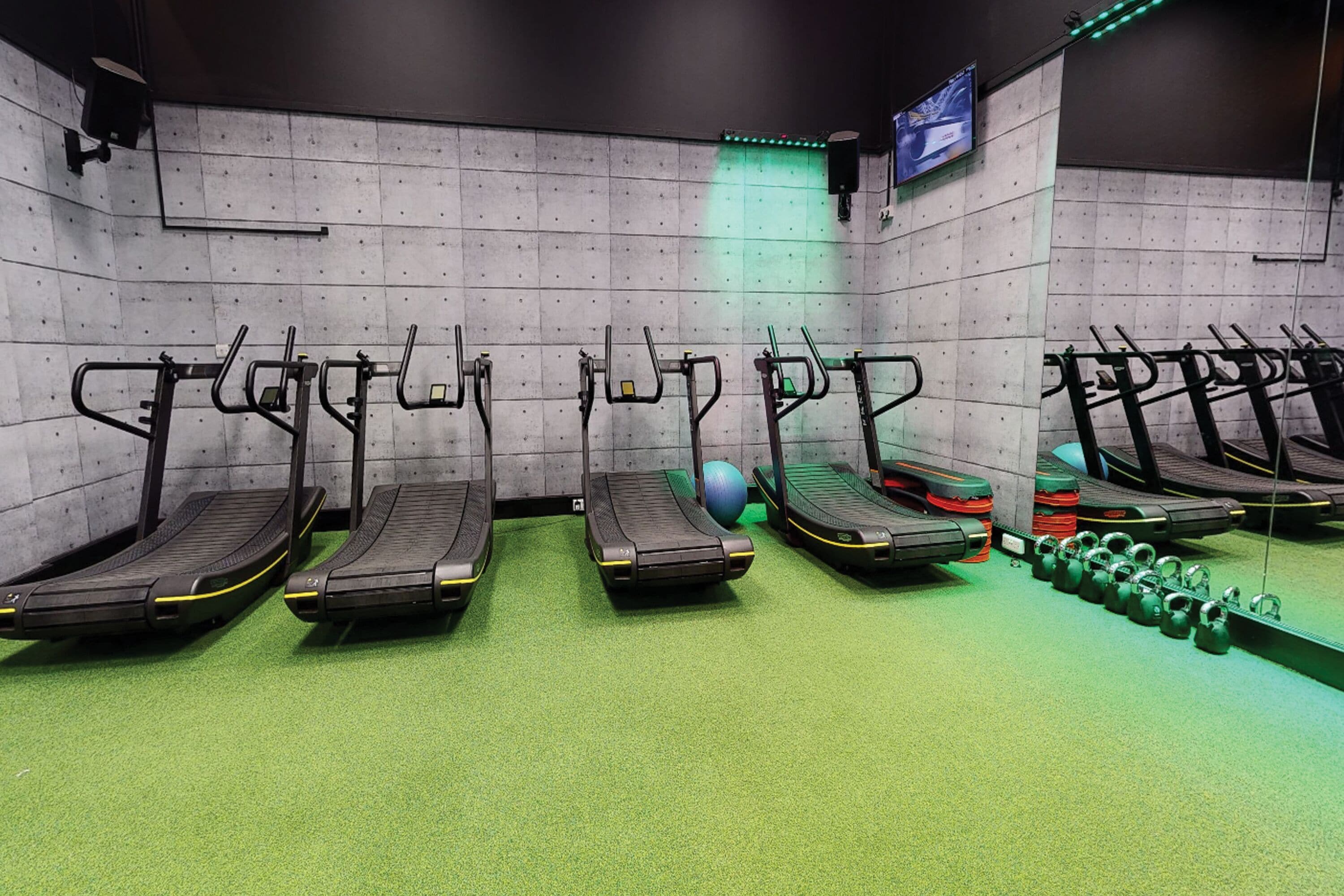 A gym with treadmills, a stationary bike, and a rowing machine.