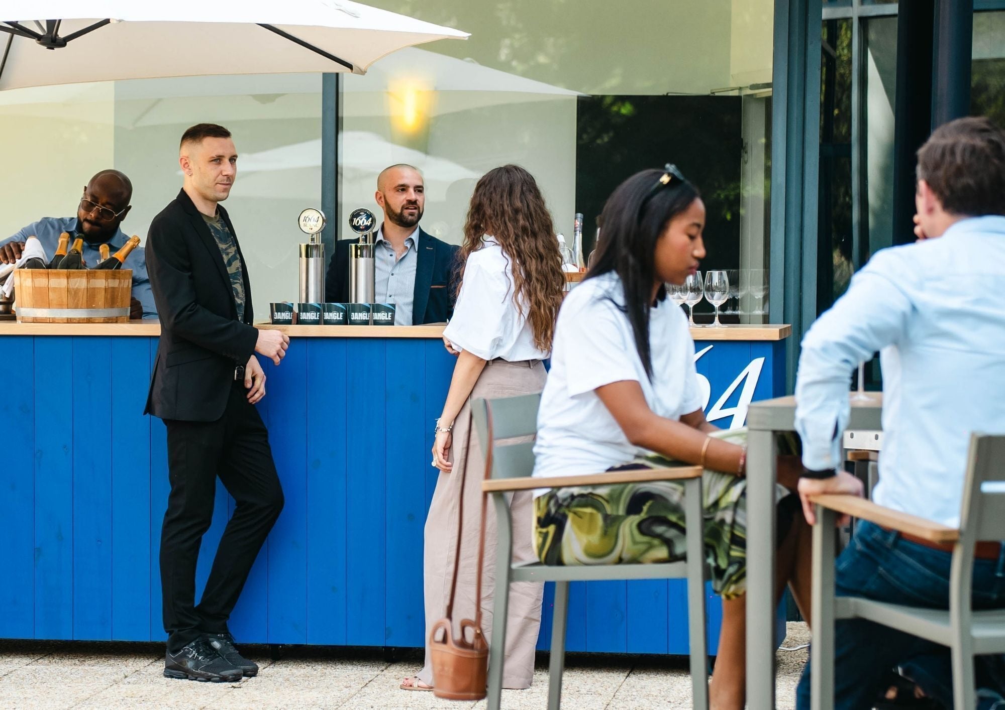 An outdoor seating area with a blue counter and numbered tables.