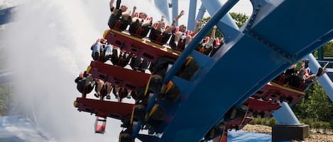 A water ride with a blue structure and a pool at the base.
