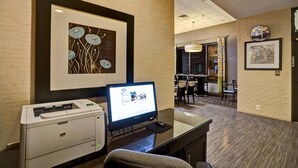 A hotel workspace with a desktop computer, printer, and framed artwork on the wall. - Hampton Inn Norfolk-Naval Base (Norfolk)