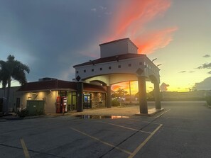 A building with a distinctive architectural style, featuring a central archway and a flat roof. - Days Inn by Wyndham Fort Myers (Fort Myers)
