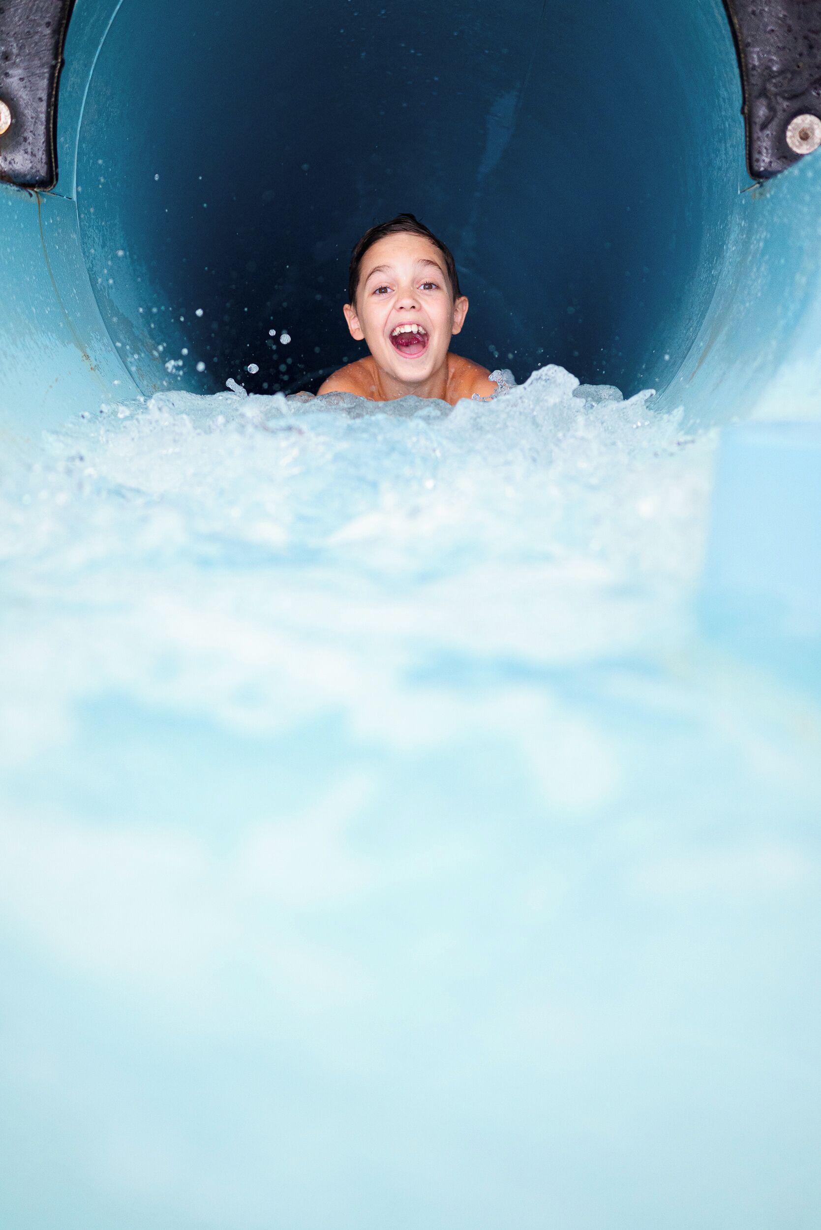 A child sliding down a water slide.