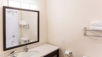 A bathroom with a sink, mirror, towel rack, and toilet.