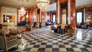 A grand lobby with checkered flooring, ornate chandeliers, and classic furniture. - The Westin Excelsior, Rome (Rome)