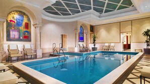 A large indoor swimming pool with lounge chairs and a ceiling with a starry design. - The Westin Excelsior, Rome (Rome)