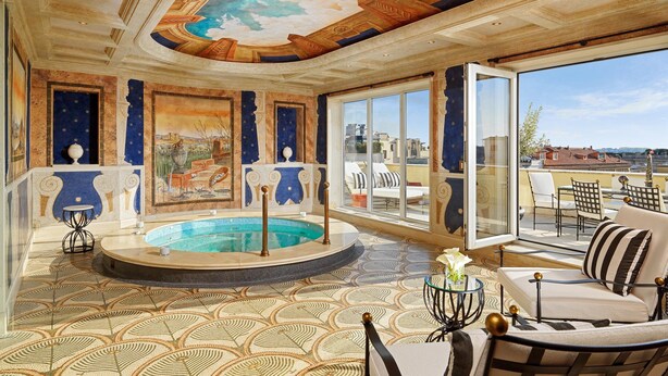 A luxurious indoor pool area with a circular pool, large windows, and a view of the cityscape. - The Westin Excelsior, Rome (Rome)