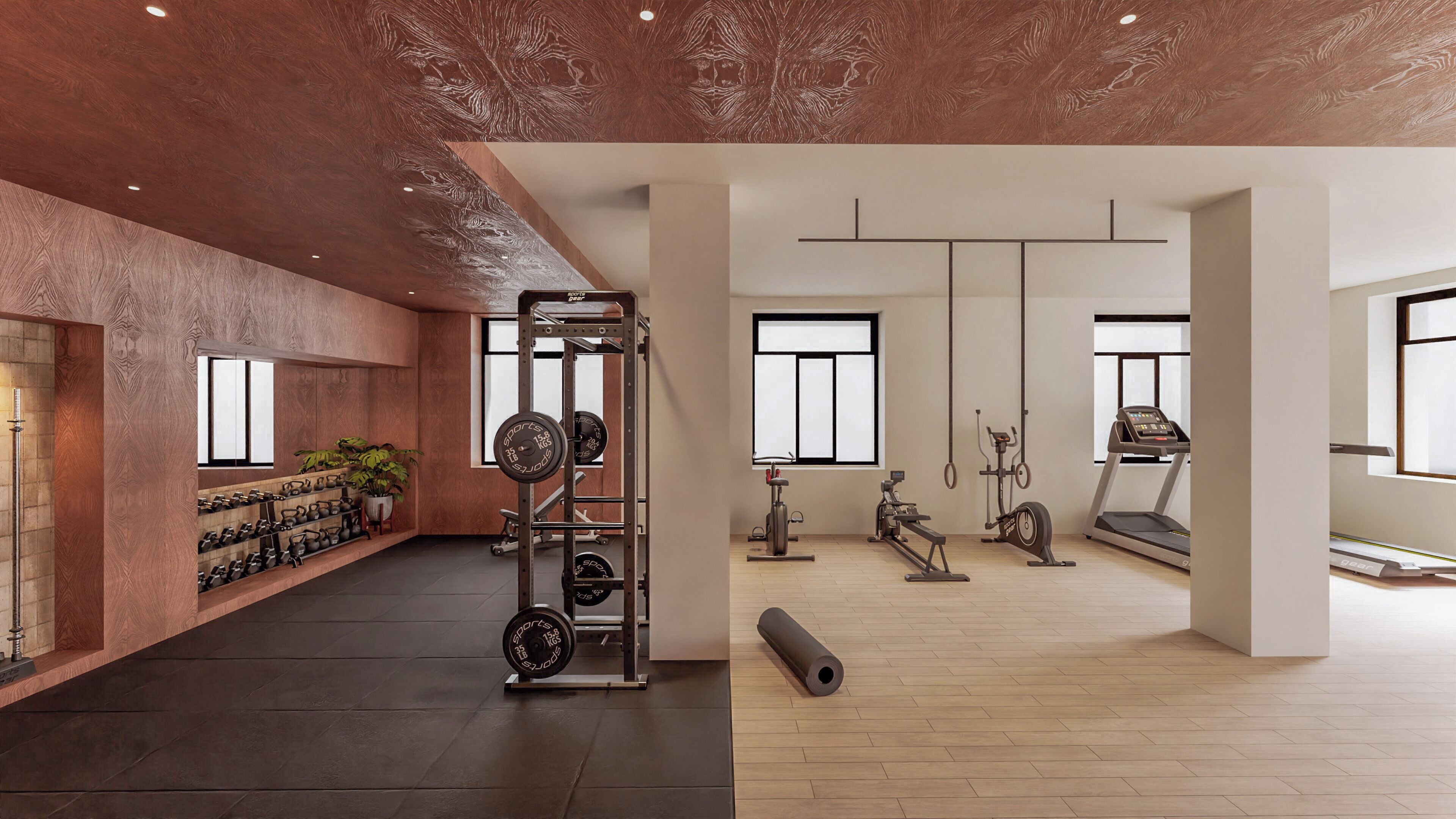 Un gimnasio con equipamiento de levantamiento de pesas, máquinas de cardio y un amplio ventanal.