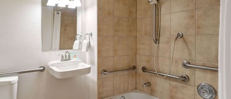 A bathroom with a bathtub, a sink, and a shower.