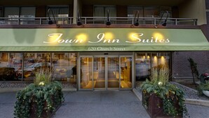 Town Inn Suites at 620 Church Street with a green awning, glass entrance, and outdoor plants. - Town Inn Suites Hotel (Toronto)