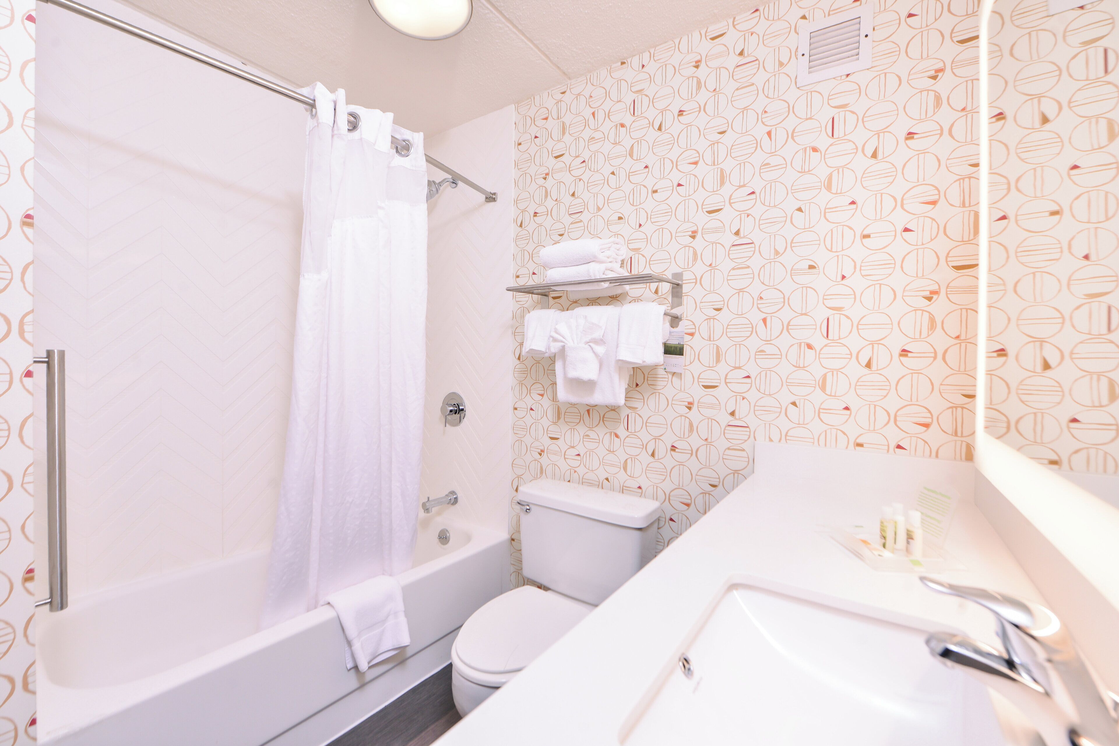 A bathroom with a bathtub, toilet, and a sink.
