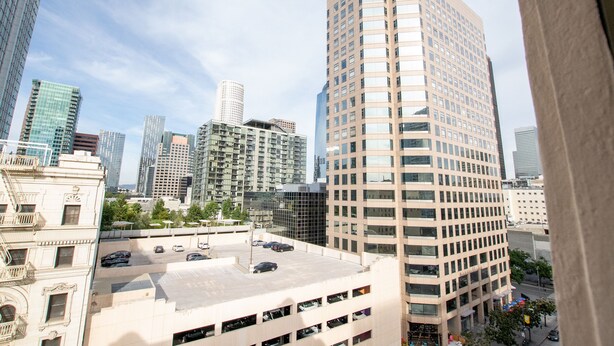 A high-rise building with a parking garage below.
