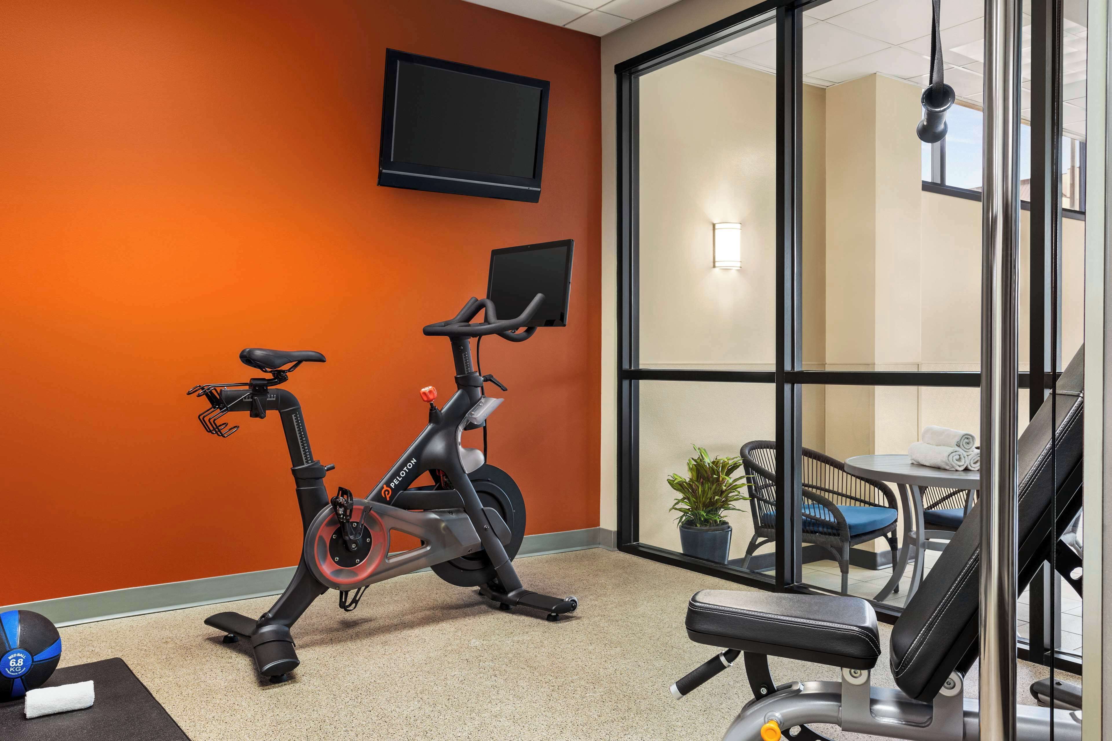 An indoor exercise area with stationary bikes, a treadmill, and a massage chair.