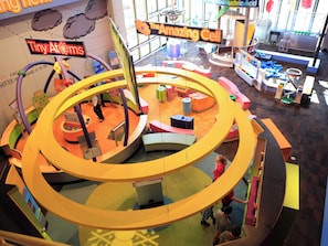 A children's play area with multiple levels and colorful structures.