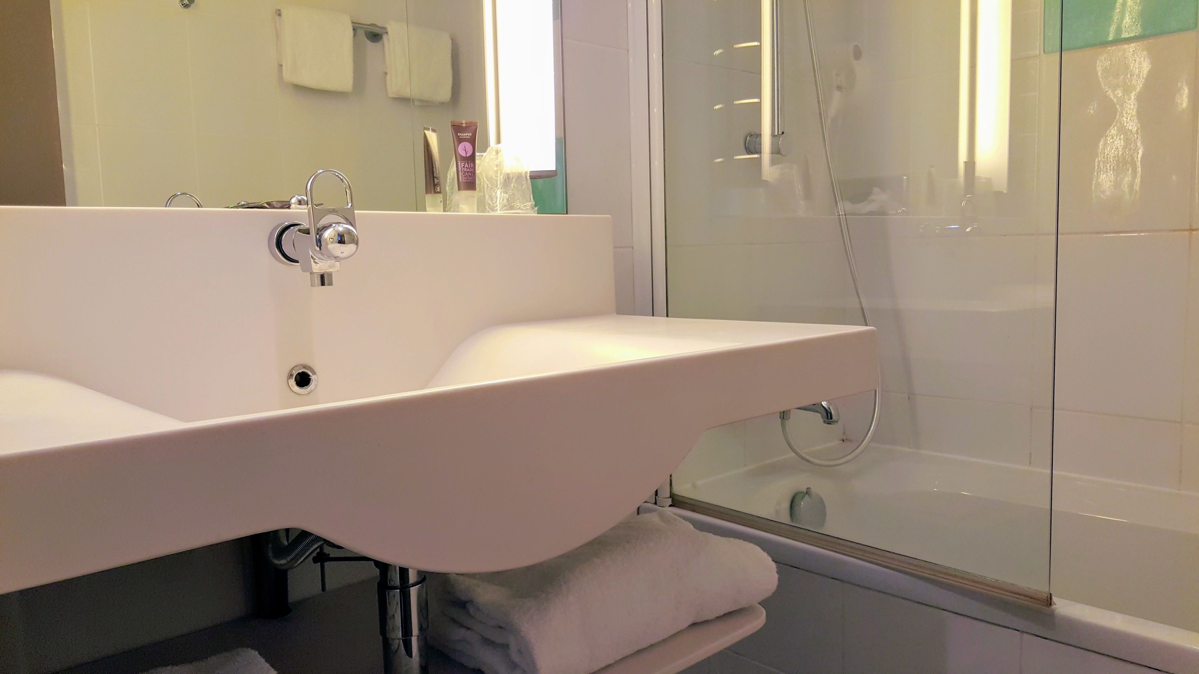 A modern bathroom with a large white bathtub, a separate shower area, and a glass-enclosed shower stall.