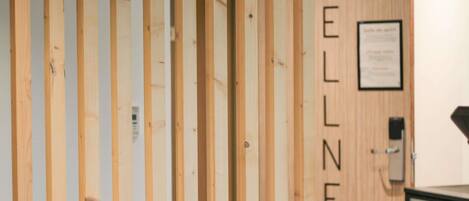 A wooden partition with the word "WELLNESS" vertically aligned.