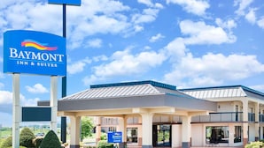 A Baymont Inn & Suites building with a prominent sign, a covered entrance, and a parking lot. - Baymont by Wyndham Clarksville Northeast (Clarksville)