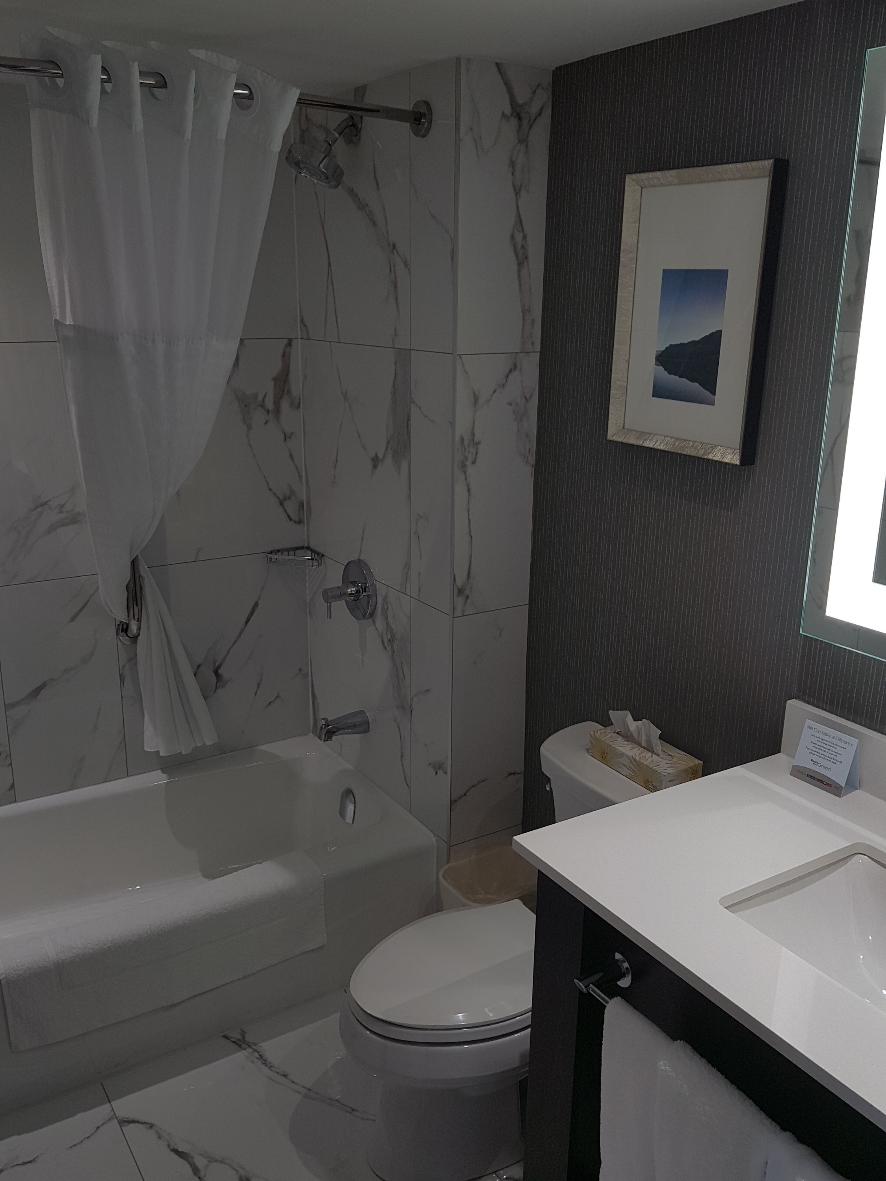 A bathroom with a bathtub, toilet, and sink.