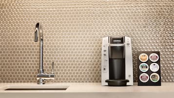 A coffee machine with a coffee pod holder on a countertop.