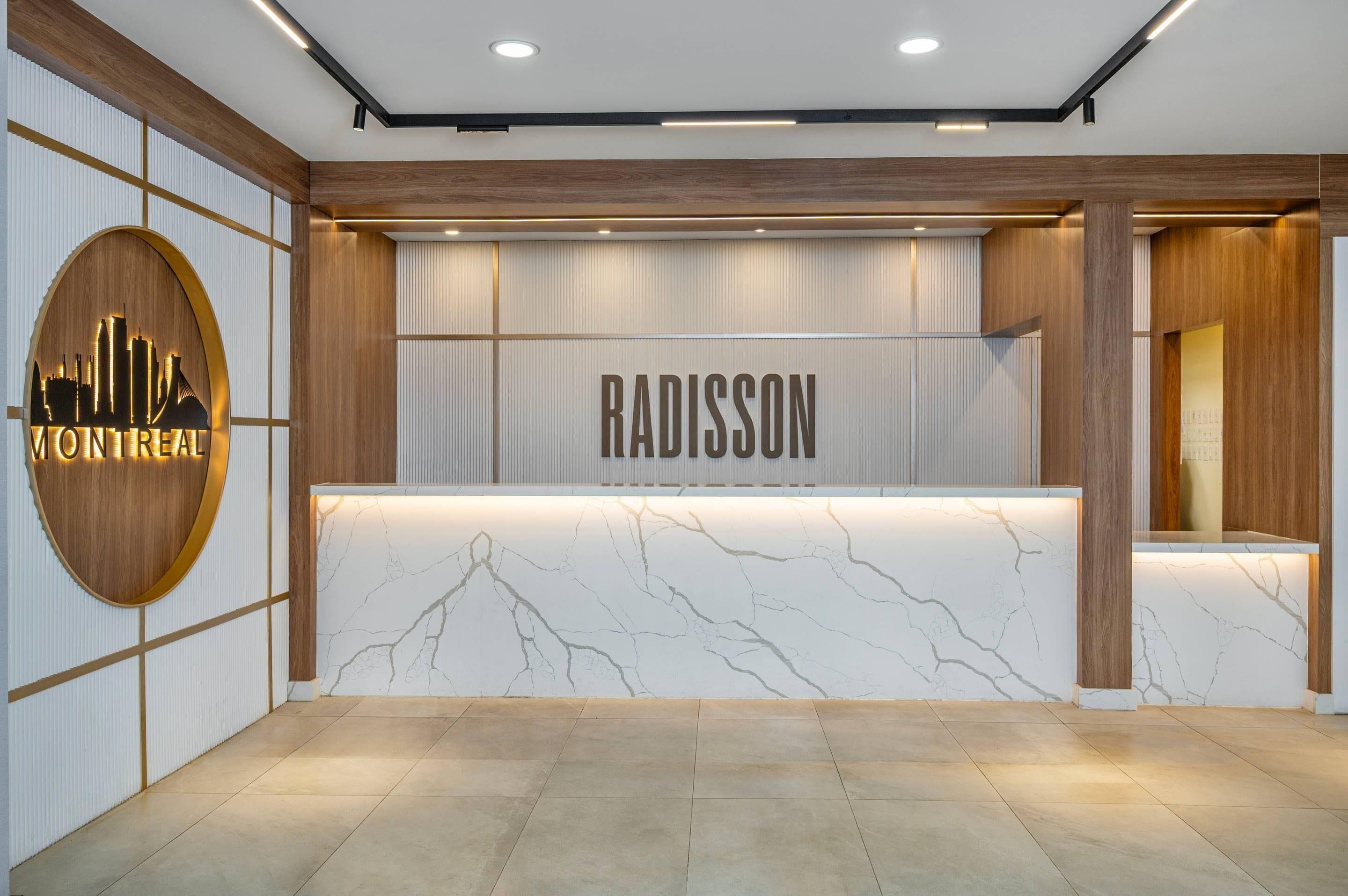 A reception desk with a marble top and a city skyline logo.