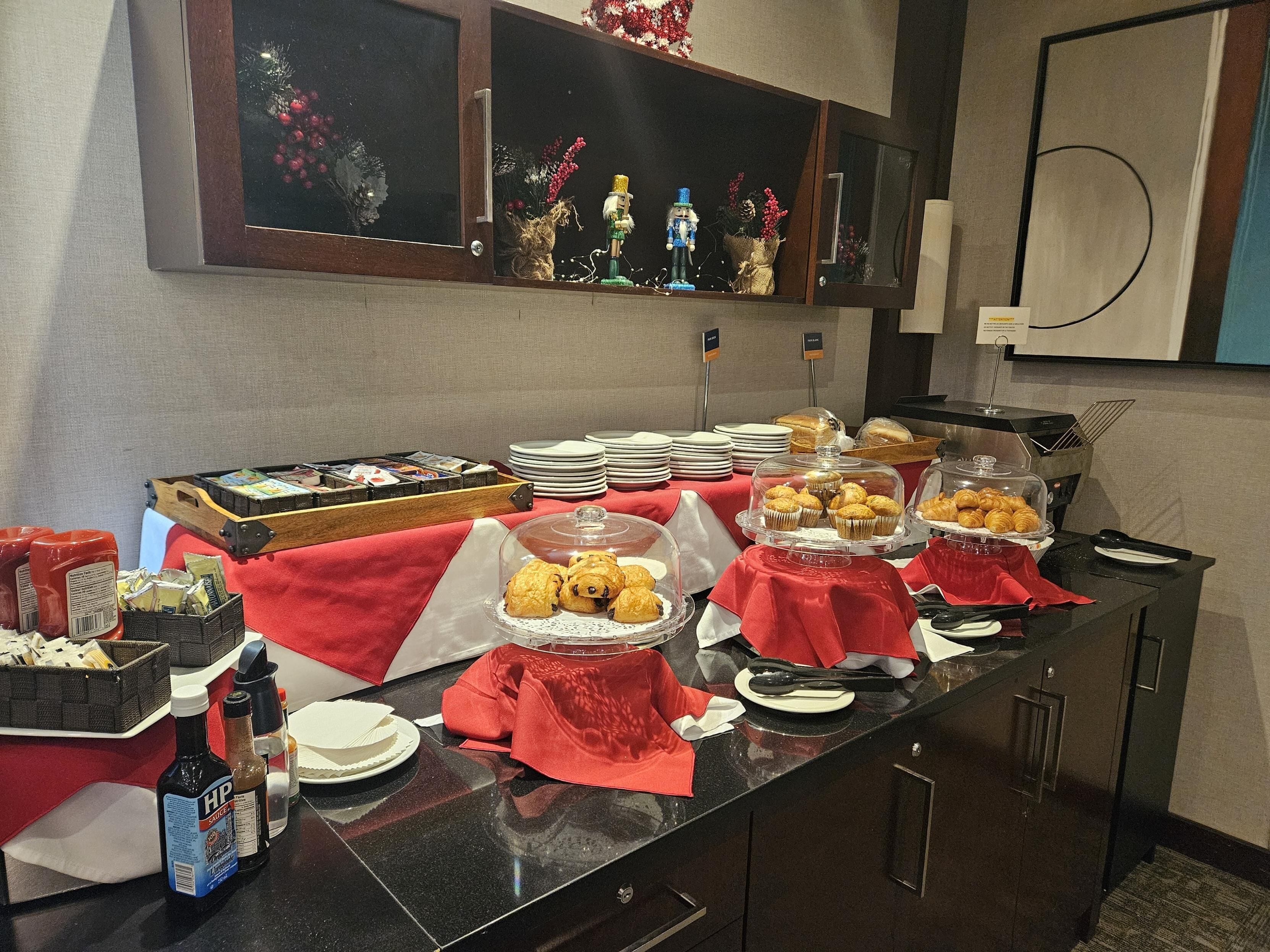 A buffet setup with various food items, condiments, and a decorative window display.