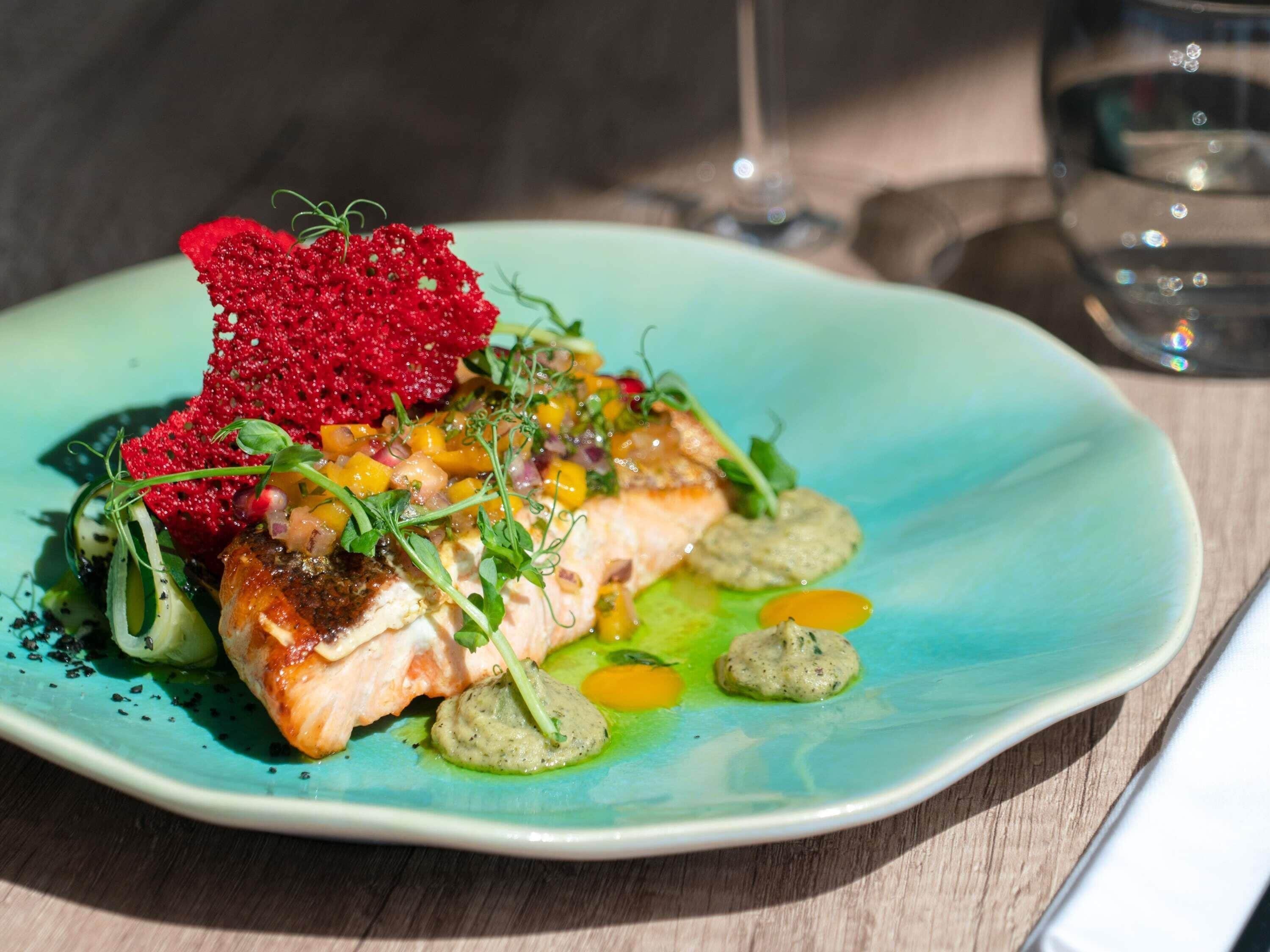 A plate of food with a variety of garnishes and sauces.