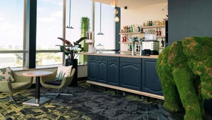 A modern bar area with a bar counter, seating, and a large window offering a city view.