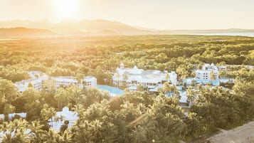 Surrounded by lush greenery and palm trees, this resort offers scenic views of the surrounding mountains.