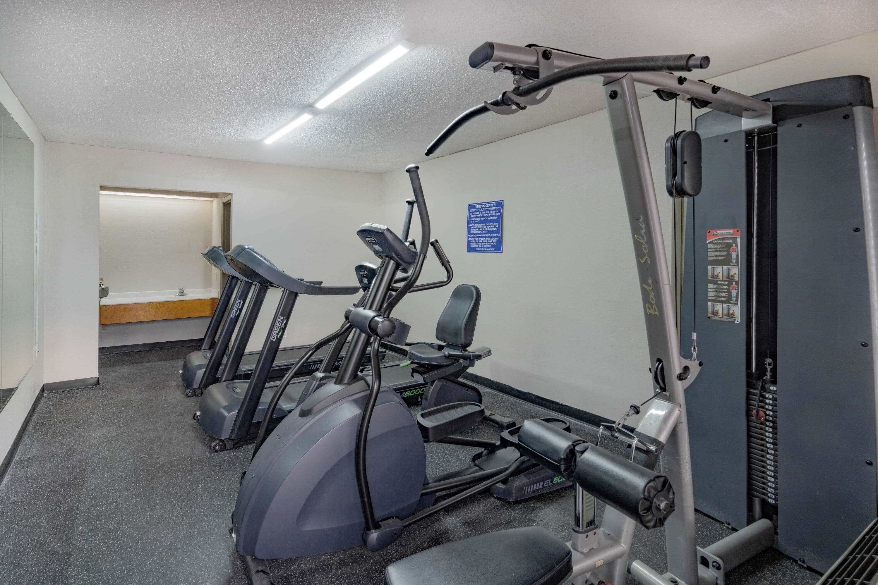A gym with treadmills, a stationary bike, and weight machines.