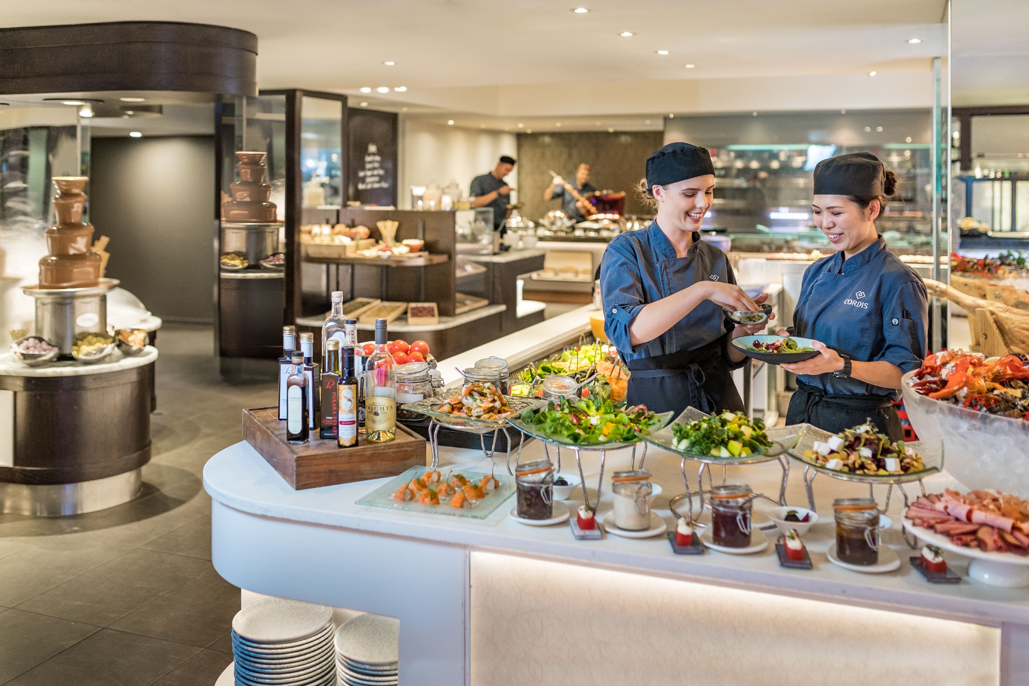 A buffet area with various food items and condiments.