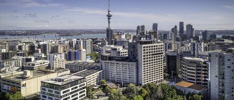 A cityscape with a prominent tower, various high-rise buildings, and a mix of commercial and residential structures.
