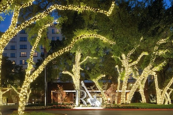 A multi-level building with a series of balconies and staircases. at Renaissance Austin Arboretum Domain Hotel